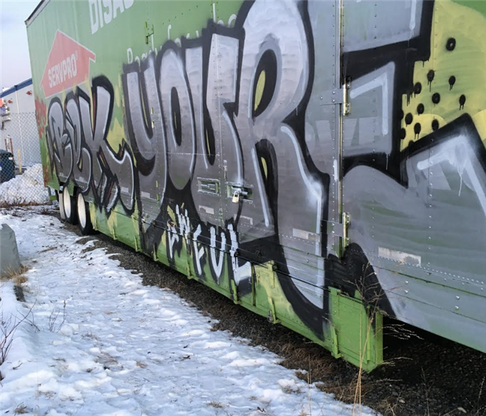 green semi truck covered in graffiti