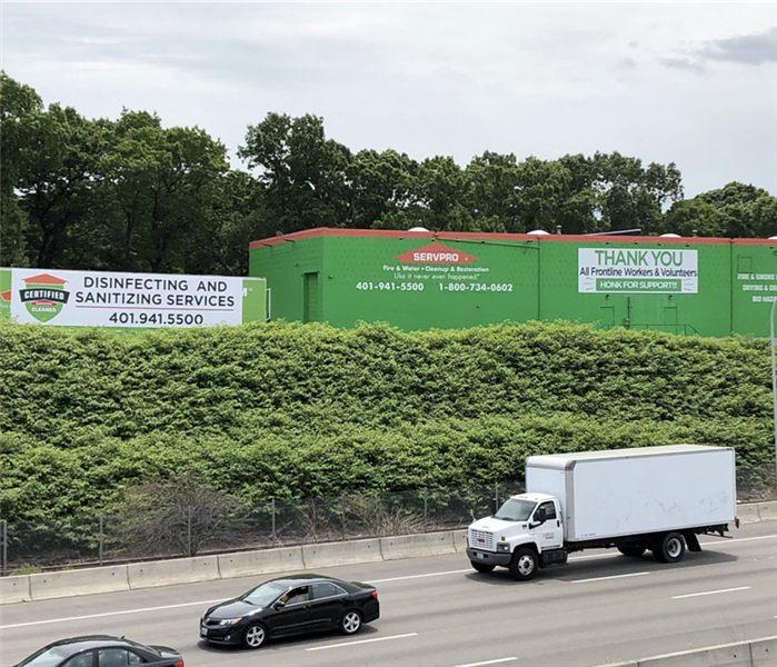 a green SERVPRO building across the highway